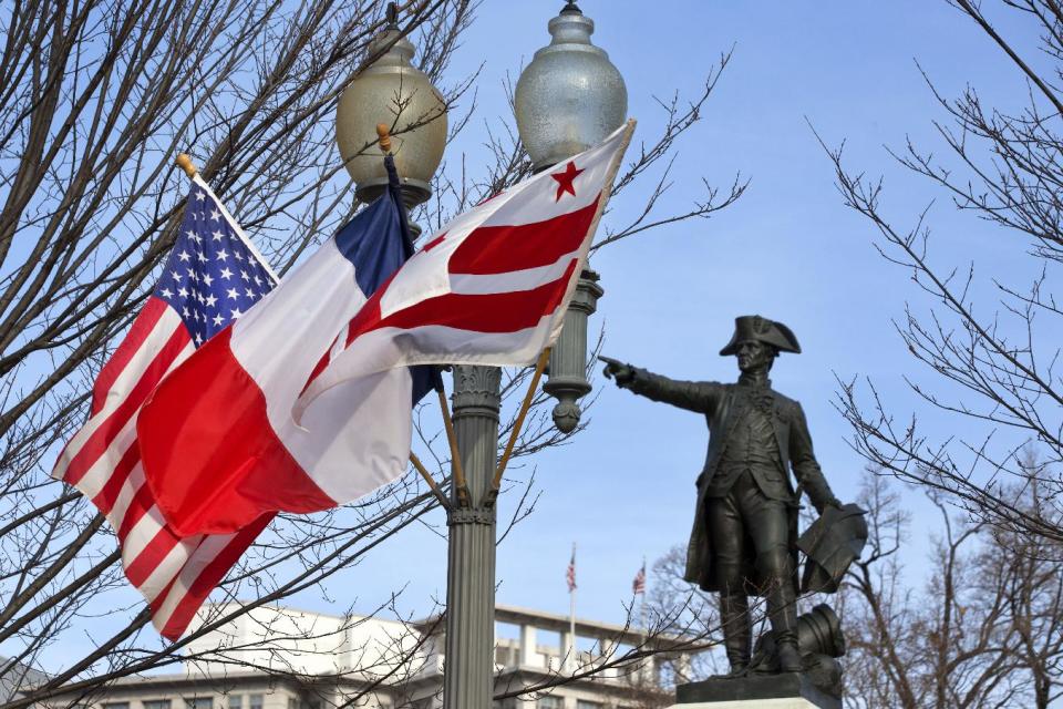 U.S., French, and Washington, D.C. flags fly on a light pole across the street from the White House in Washington, Monday, Feb. 10, 2014, in anticipation of a State Visit from French President Francois Hollande. (AP Photo/Jacquelyn Martin)