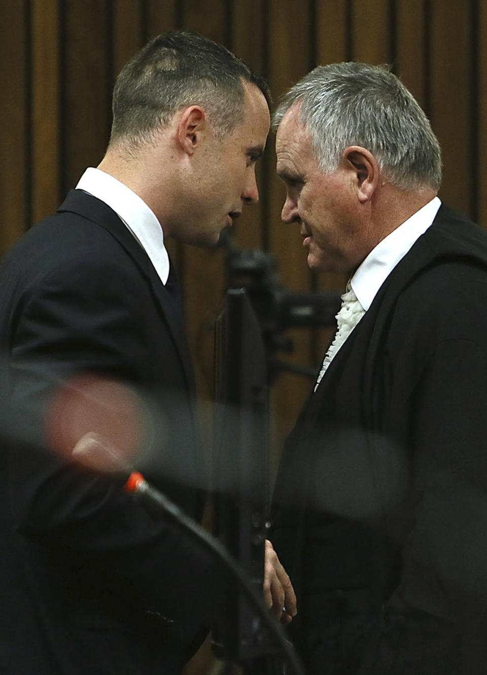 Oscar Pistorius, right, and his defense attorney Barry Roux, left, attend his murder trial at a court in Pretoria, South Africa, Tuesday May 6, 2014. Pistorius is charged with the shooting death of his girlfriend Reeva Steenkamp on Valentine's Day in 2013. (AP Photo/Alon Skuy, Pool)