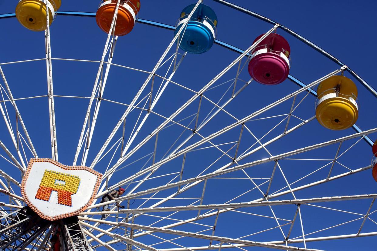 Crews work to complete the Dutch Wheel ahead of a previous opening night at the Cleveland County Fair.