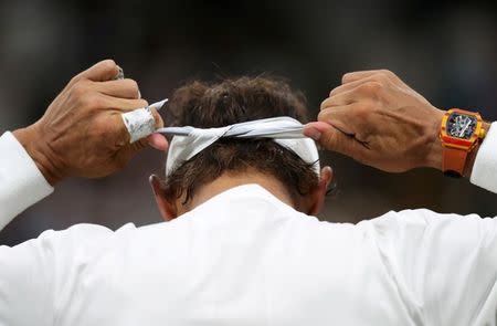 Tennis - Wimbledon - All England Lawn Tennis and Croquet Club, London, Britain - July 13, 2018. Spain's Rafael Nadal adjusts his headband during his semi final match against Serbia's Novak Djokovic . Daniel Leal-Olivas/Pool via Reuters