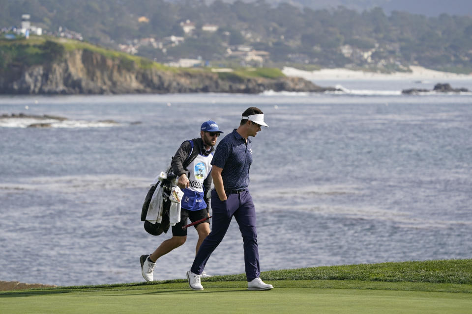 Beau Hossler walks up to the 18th green of the Pebble Beach Golf Links during the third round of the AT&T Pebble Beach Pro-Am golf tournament in Pebble Beach, Calif., Saturday, Feb. 5, 2022. (AP Photo/Eric Risberg)