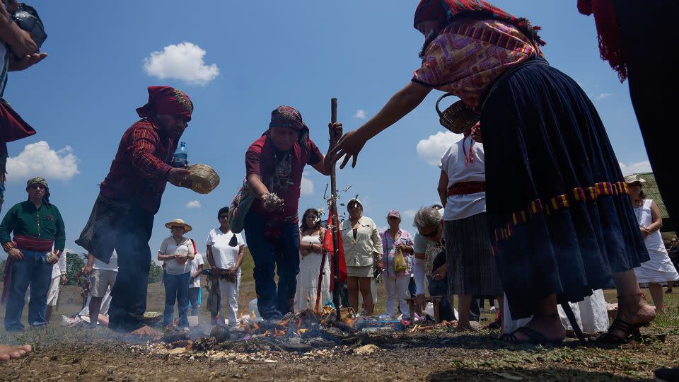 Salvadoran indigenous people deliver offerings to the fire during the celebration of the spring equinox 2023 at the archaeological site of San Andrés in the Zapotitán Valley of El Salvador. - Alex Pena/Anadolu Agency/Getty Images