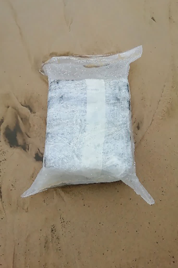 A suspicious package allegedly containing cocaine lies on the sand on the Plage du Gressier in Le Porge, southwestern France. Source: AFP