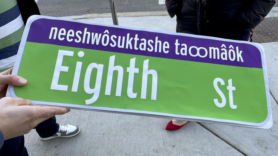 This photo taken on Dec. 14, 2023 provided by Sarah Burks shows a paper mockup of the street signs that will go up next year in some parts of Cambridge, Mass. and include the language of the Massachusett Tribe. (Sarah Burks via AP)