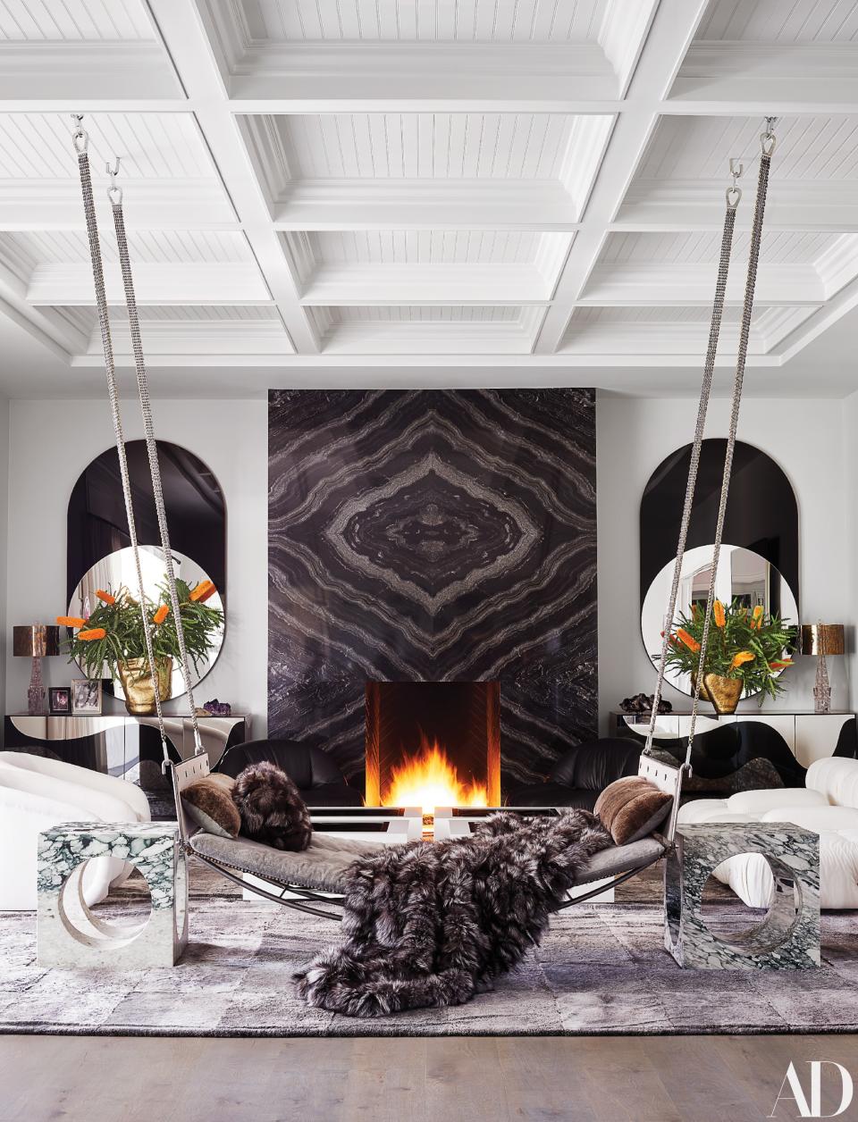 A Jim Zivic hammock from Ralph Pucci hangs in the family room. Bower mirrors from the Future Perfect; Tom Dixon brass vases; Kelly Wearstler marble side tables.