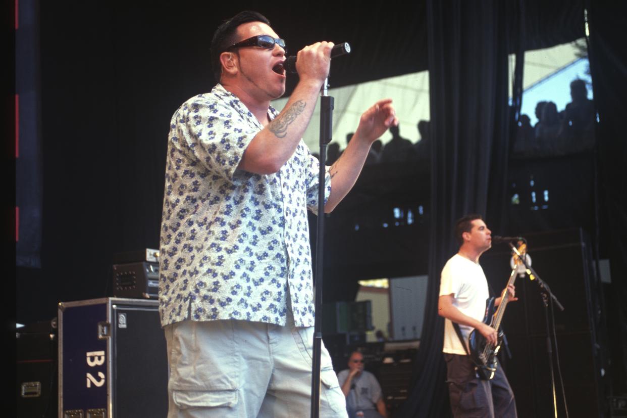 Steve Harwell of Smash Mouth, wearing sunglasses and a tropical short-sleeve shirt, with a bass player at right, performs at Shoreline Amphitheatre in Mountain View, Calif. 