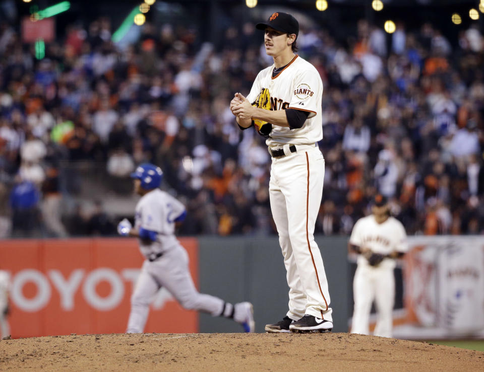 San Francisco Giants starting pitcher Tim Lincecum stands on the mound as Los Angeles Dodgers' Juan Uribe, left, rounds the bases on a solo home run in the second inning of a baseball game Tuesday, April 15, 2014, in San Francisco. (AP Photo/Marcio Jose Sanchez)