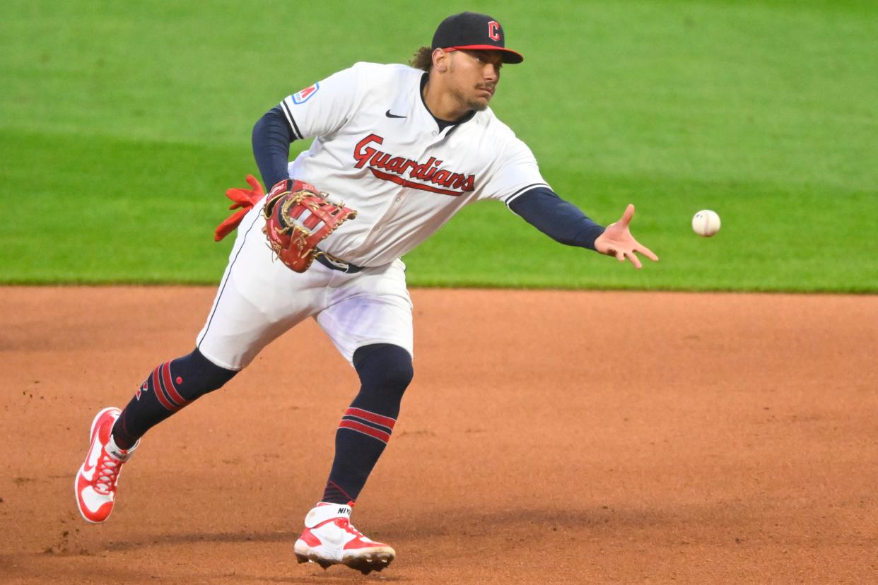 Cleveland Guardians first baseman Josh Naylor (22) tosses the ball to first base in the seventh inning against the New York Yankees on Saturday in Cleveland.