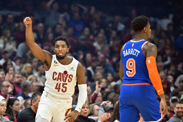 RJ Barrett of the New York Knicks hangs on the basket after dunking News  Photo - Getty Images