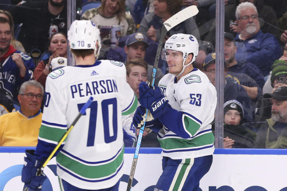 Vancouver Canucks forward Bo Horvat (53) celebrates his goal with teammate forward Tanner Pearson (70) during the second period of an NHL hockey game against the Buffalo Sabres, Saturday, Jan. 11, 2020, in Buffalo, N.Y. (AP Photo/Jeffrey T. Barnes)