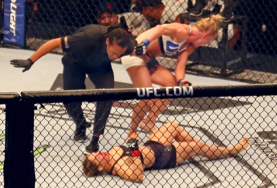 MELBOURNE, AUSTRALIA - NOVEMBER 15:  Referee Herb Dean ends the fight as New UFC women's bantamweight champion Holly Holm of the United States starts to celebrate her victory over Ronda Rousey of the United States in their UFC women's bantamweight championship bout during the UFC 193 event at Etihad Stadium on November 15, 2015 in Melbourne, Australia.  (Photo by Scott Barbour /Zuffa LLC/Zuffa LLC via Getty Images)