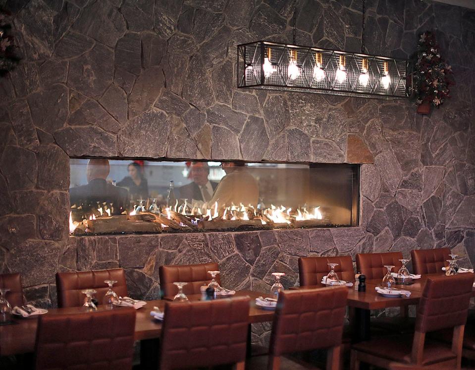 The fireplace at Grille 151 in Weymouth has two sides. Wednesday, Dec. 15, 2021.