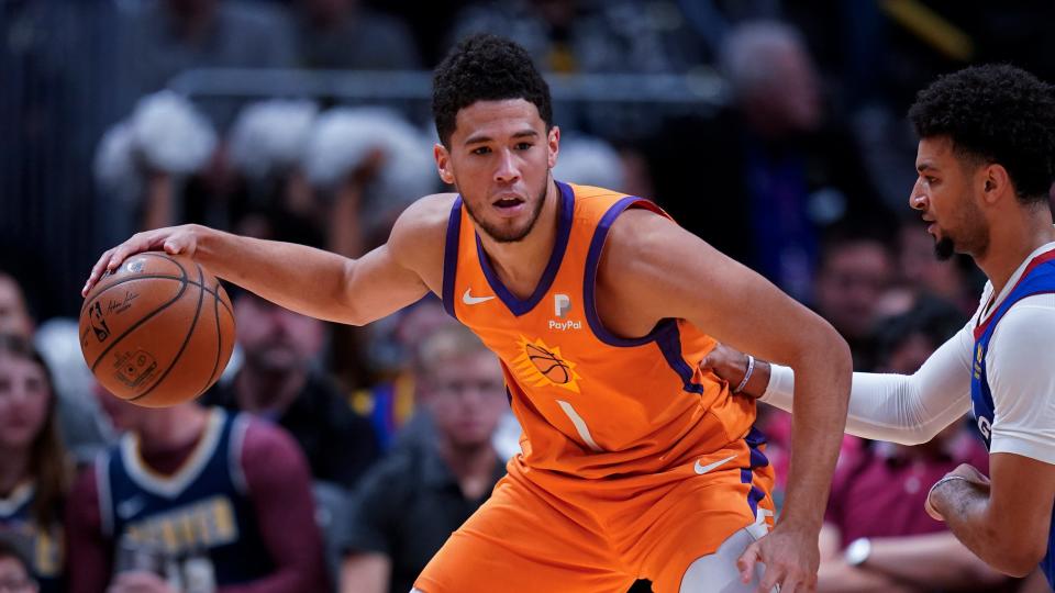 Phoenix Suns guard Devin Booker moves against the Denver Nuggets during the second quarter of an NBA basketball game, Friday, Oct. 25, 2019, in Denver. (AP Photo/Jack Dempsey)