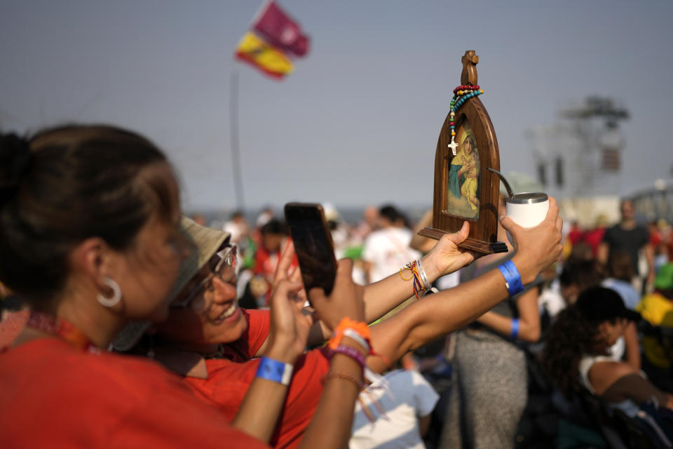 Pilgrims and faithful gather as they wait for a vigil with Pope Francis ahead of the 37th World Youth Day flock to the Parque Tejo in Lisbon, Saturday, Aug. 5, 2023. On Sunday morning, the last day of his five-day trip to Portugal, Francis is to preside over a final, outdoor Mass on World Youth Day – when temperatures in Lisbon are expected to top 40 degrees C (104F) – before returning to the Vatican. (AP Photo/Armando Franca)