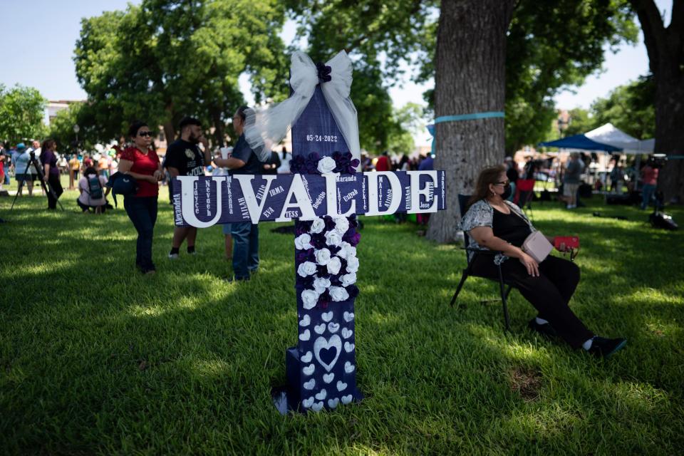 People gather at a memorial site in the town square of Uvalde set up for those killed in the mass shooting at Robb Elementary School, Sunday, May 29, 2022, in Uvalde, Texas (AP)