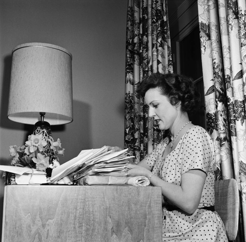 <p>Hollywood's <em>Golden Girl </em>sits at her desk as she sorts through mail and packages. </p>