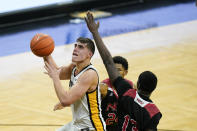 Iowa center Luka Garza, left, drives to the basket past Northern Illinois center Adong Makuoi, right, during the first half of an NCAA college basketball game, Sunday, Dec. 13, 2020, in Iowa City, Iowa. (AP Photo/Charlie Neibergall)