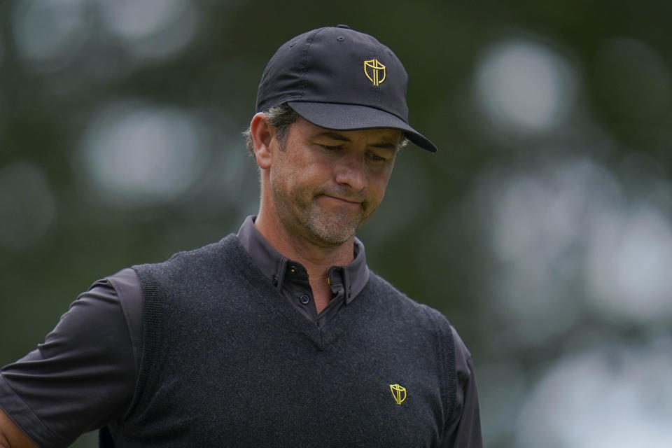 Adam Scott, of Australia, reacts to his ball's flight off the sixth tee during their singles match at the Presidents Cup golf tournament at the Quail Hollow Club, Sunday, Sept. 25, 2022, in Charlotte, N.C. (AP Photo/Julio Cortez)