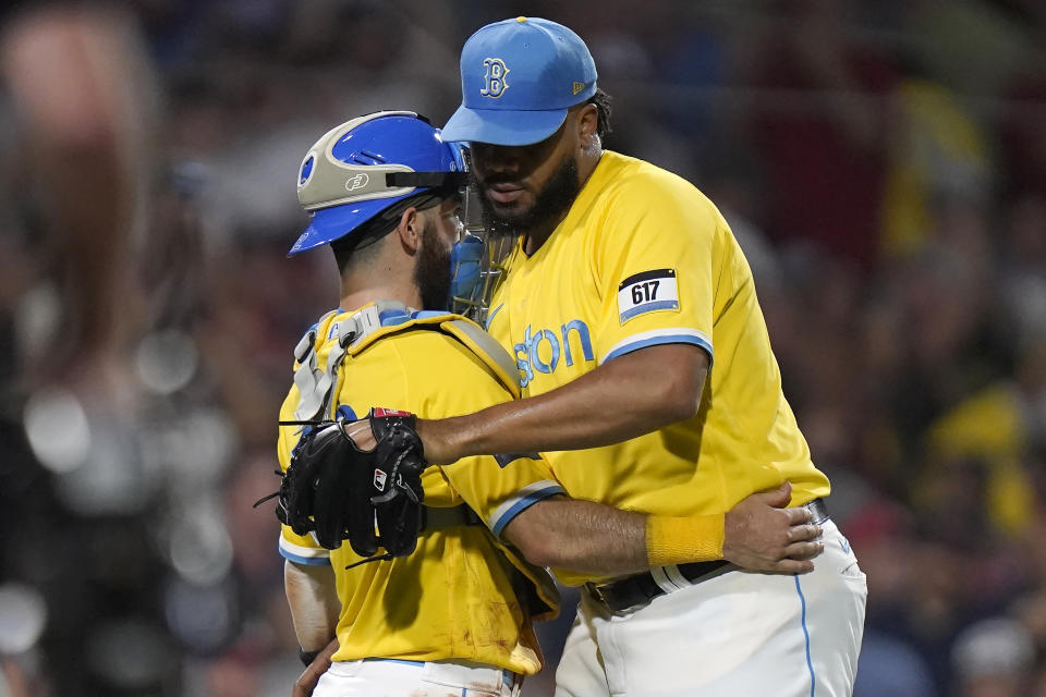 Boston Red Sox's Connor Wong, left, celebrates with Kenley Jansen after the Red Sox beat the Atlanta Braves in a baseball game, Wednesday, July 26, 2023, in Boston. (AP Photo/Steven Senne)