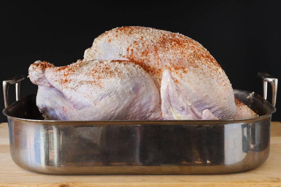 Raw turkey on roasting pan