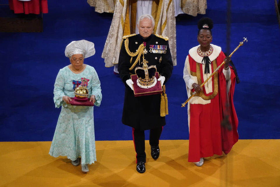 Baroness Floella Benjamin (R), carrying the The Sovereign's Sceptre with the Dove, General Sir Gordon Messenger, (C) the Governor of HM Tower of London, carrying St Edward's Crown as Lord High Steward of England, and Dame Elizabeth Anionwu (L) during the coronation ceremony in Westminster Abbey, on May 6, 2023 in London, England. The Coronation of Charles III and his wife, Camilla, as King and Queen of the United Kingdom of Great Britain and Northern Ireland, and the other Commonwealth realms takes place at Westminster Abbey today. Charles acceded to the throne on 8 September 2022, upon the death of his mother, Elizabeth II. (Photo by Andrew Matthews - WPA Pool/Getty Images)