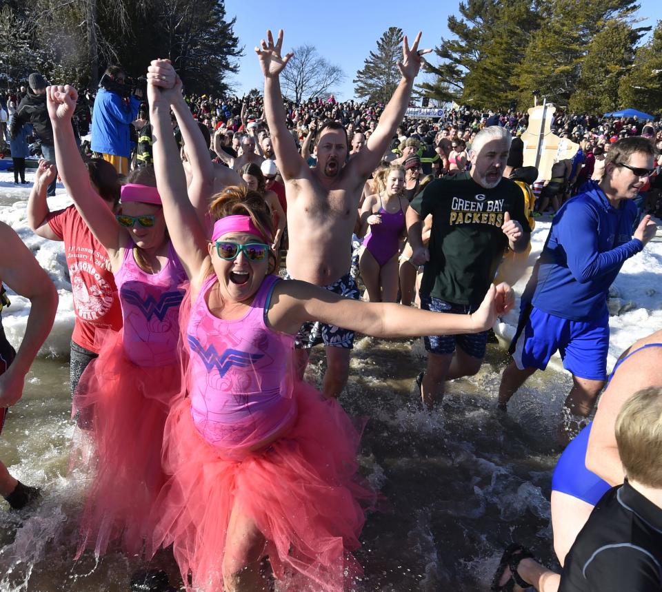 New Year's Day revelers run into a frigid Lake Michigan at Lakeside Park in Jacksonport during a past annual polar plunge sponsored by the Jacksonport Polar Bear Club. Hundreds are expected to take part in the 36th annual swim Jan. 1.