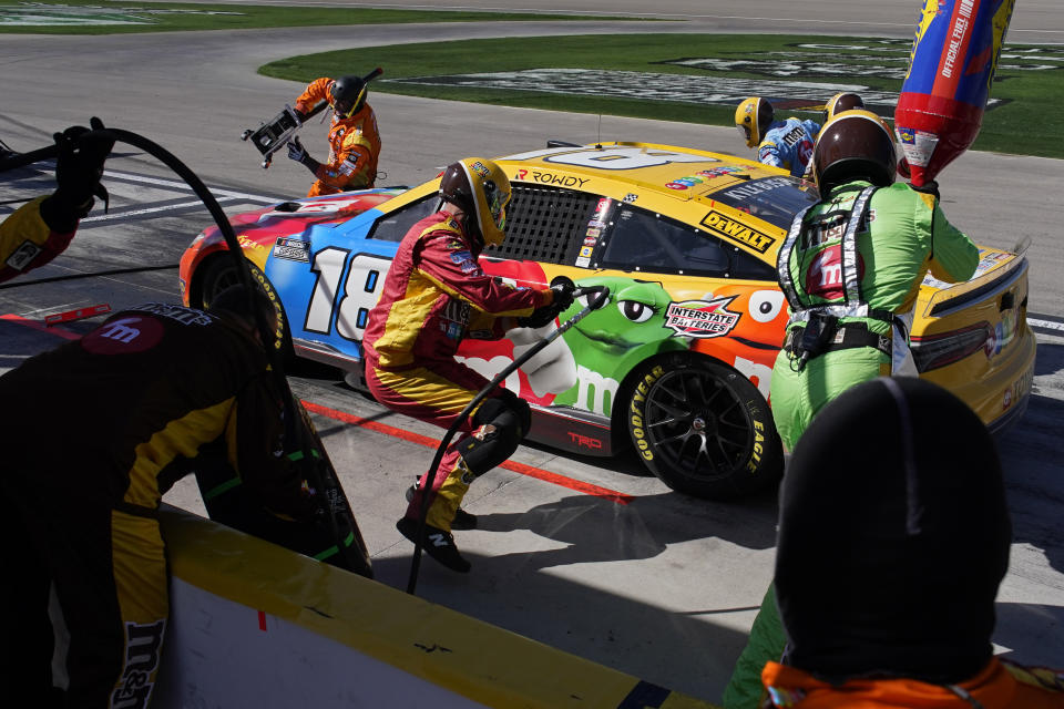 Kyle Busch (18) makes a pit stop during a NASCAR Cup Series auto race Sunday, Oct. 16, 2022, in Las Vegas. (AP Photo/John Locher)