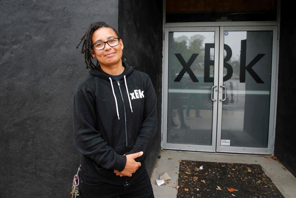 Tobi Parks, owner of xBk Live, poses for a photo outside her building.