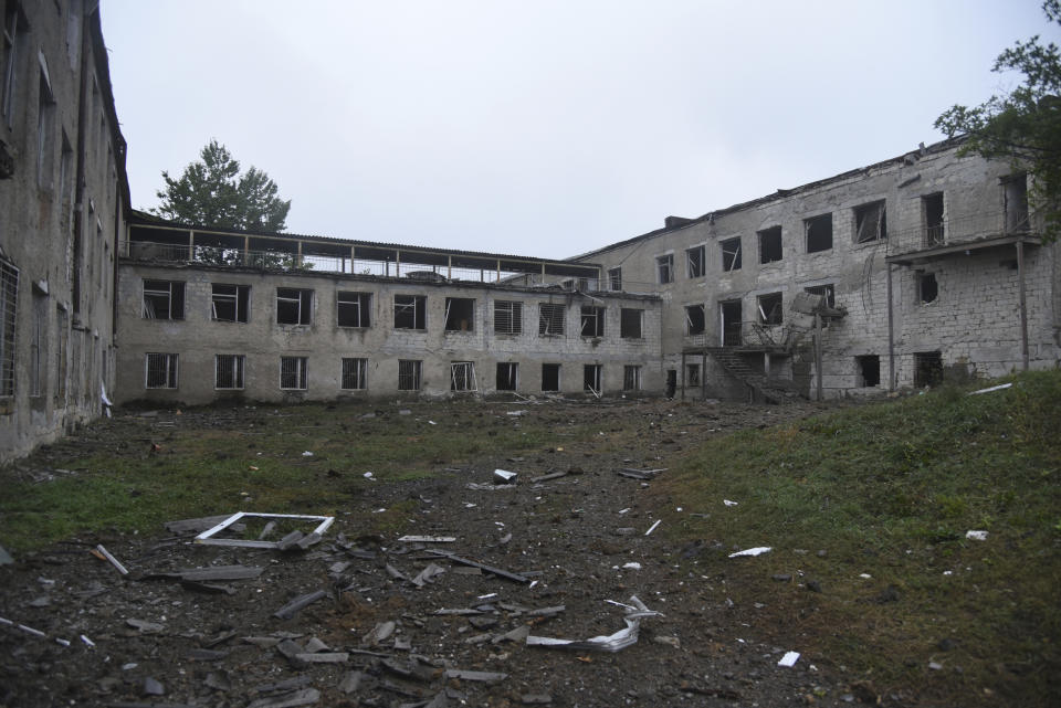 A view of school damaged after shelling by Azerbaijan's artillery during a military conflict in Stepanakert, self-proclaimed Republic of Nagorno-Karabakh, Azerbaijan, Monday, Oct. 5, 2020. Armenia accused Azerbaijan of firing missiles into the capital of the separatist territory of Nagorno-Karabakh, while Azerbaijan said several of its towns and its second-largest city were attacked. (David Ghahramanyan/NKR InfoCenter PAN Photo via AP)