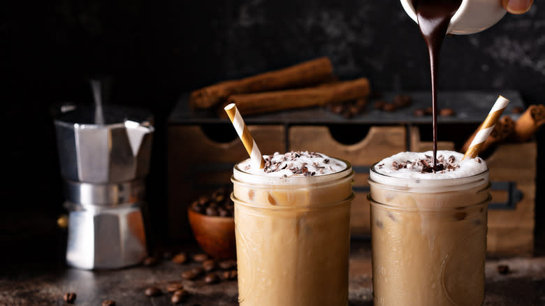 Two lattes with chocolate syrup and moka pot