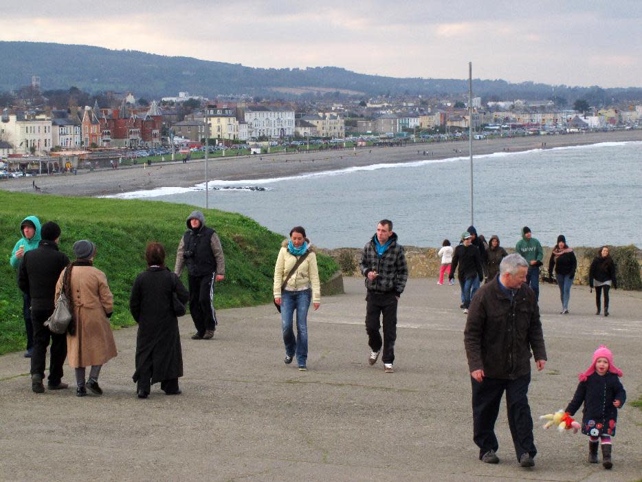 This Feb. 17, 2013 photo shows hikers on the Bray-to-Greystones cliff walk south of Dublin, Ireland. The Victorian resort town of Bray is in the background. The 8-kilometer (5-mile) path offers panoramic views of the Irish Sea and is among the most popular in the greater Dublin area. (AP Photo/Shawn Pogatchnik)