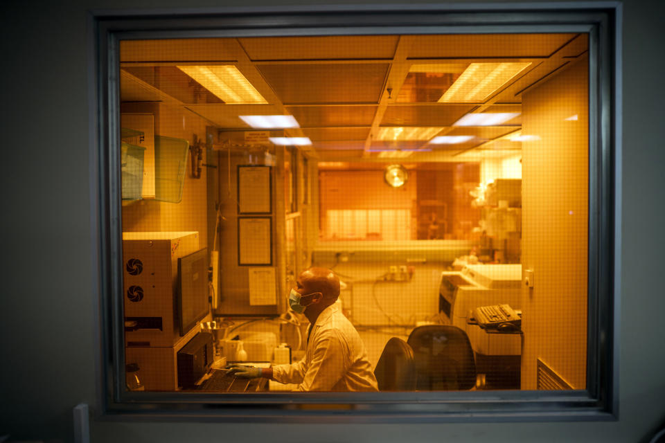 FILE — Sandile Cele, a researcher at the Africa Health Research Institute in Durban, South Africa, works on the omicron variant of the COVID-19 virus Wednesday Dec. 15, 2021. South Africa's noticeable drop in new COVID-19 cases in recent days may signal that the country's dramatic omicron-driven wave has passed its peak, medical experts say. (AP Photo/Jerome Delay, File)