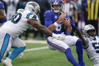 Carolina Panthers' Brian Burns (53) sacks New York Giants quarterback Daniel Jones (8) as DaQuan Jones (90) closes in during the second half of an NFL football game, Sunday, Oct. 24, 2021, in East Rutherford, N.J. (AP Photo/Seth Wenig)