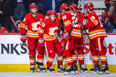 Feb 20, 2019; Calgary, Alberta, CAN; Calgary Flames left wing Johnny Gaudreau (13) celebrates with teammates after scoring a goal against the New York Islanders during the third period at Scotiabank Saddledome. Mandatory Credit: Sergei Belski-USA TODAY Sports