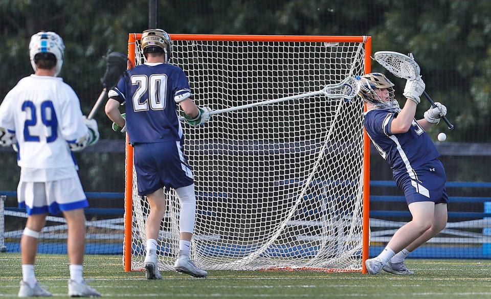 Hanover goalie Ronan Kearney takes a shot to the chest and blocks it.Norwell and Hanover battle it out on the lacrosse field in the MIAA Div. 3 semi finals on Friday June 17, 2022.