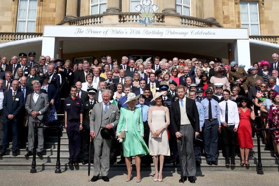 Posing for a photograph outside Buckingham Palace.