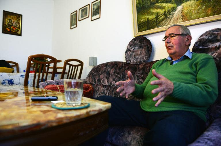 Harald Jaeger, a retired Lieutenant Colonel in the former east German secret police Stasi, speaks to journalists at his home in Werneuchen, north of Berlin, on November 4, 2014