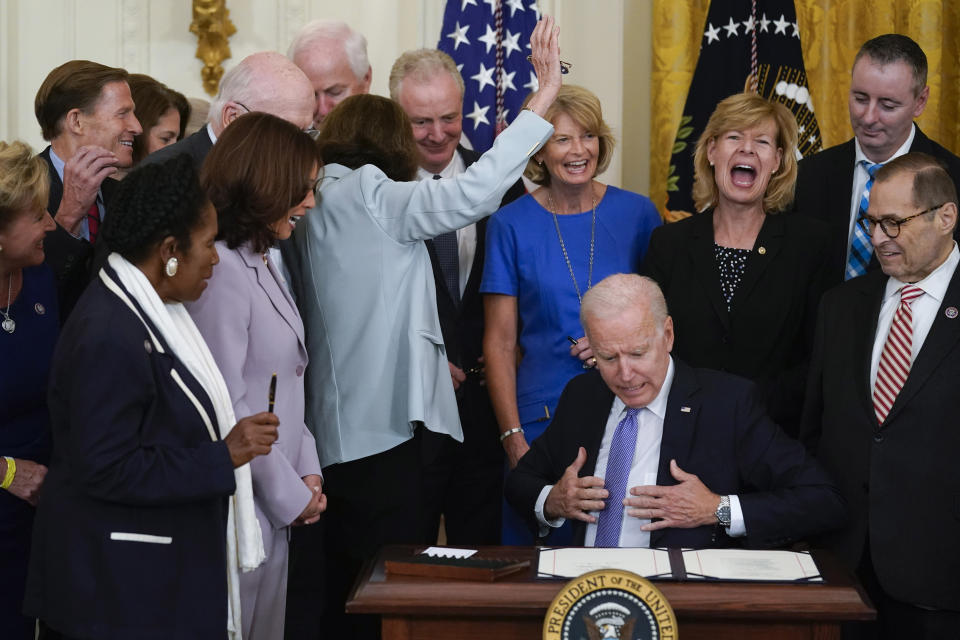 After not receiving a pen, Sen. Dianne Feinstein, D-Calif., raises her hand as President Joe Biden reacts after he ran out of pens to hand out after he signed H.R. 1652, the VOCA Fix to Sustain the Crime Victims Fund Act of 2021, in the East Room of the White House, Thursday, July 22, 2021, in Washington. (AP Photo/Andrew Harnik)