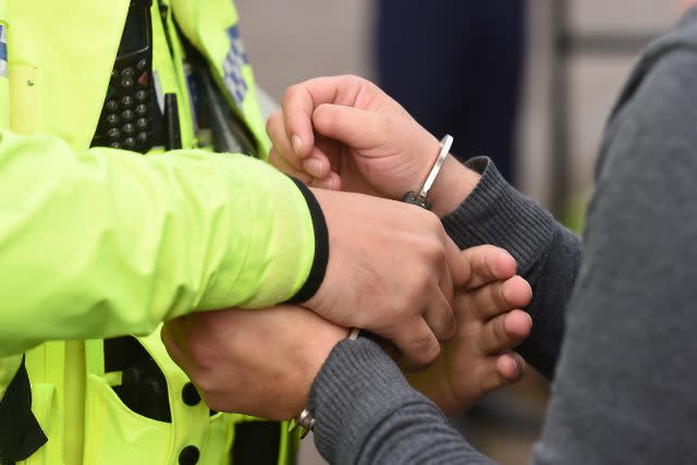 A man is handcuffed by police