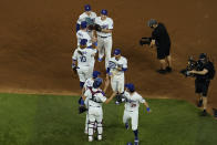 The Los Angeles Dodgers celebrate their 8-3 win against the Tampa Bay Rays in Game 1 of the baseball World Series Tuesday, Oct. 20, 2020, in Arlington, Texas. The Dodgers defeated the Rays 8-3 to lead the series 1-0 games. (AP Photo/David J. Phillip)