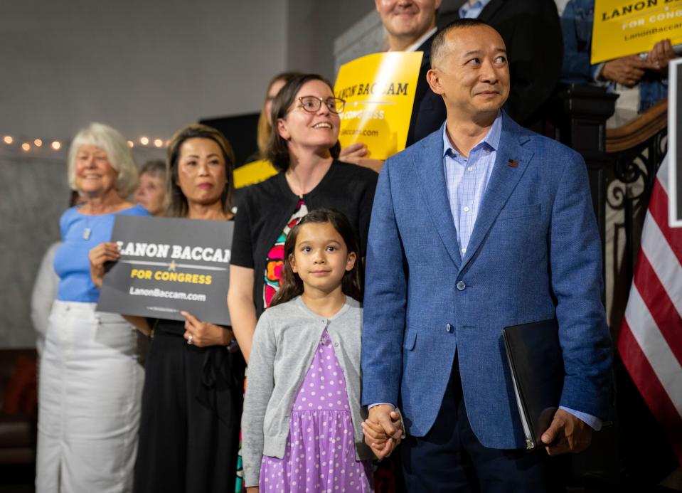 Lanon Baccam holds the hand of his daughter, Freya, as he is introduced after winning the Democratic nomination in Iowa's 3rd U.S. House District Tuesday, June 4, 2024.