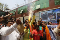 Bharatiya Janata Party (BJP) workers celebrate at BJP headquarters in, Lucknow, India, Thursday, May 23, 2019. Indian Prime Minister Narendra Modi and his party were off to an early lead as vote counting began Thursday following the conclusion of the country's 6-week-long general election, sending the stock market soaring in anticipation of another five-year term for the Hindu nationalist leader.(AP Photo/Rajesh Kumar Singh)