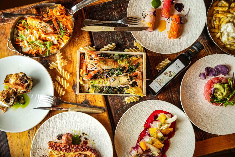 Various food items from Piccola Cucina shown on plates on a table