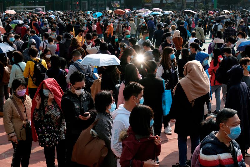 FILE PHOTO: Customers queue up to buy masks amid an outbreak of a new coronavirus, in Hong Kong