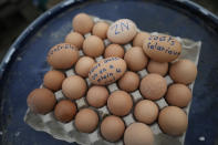 Eggs, some with demands, as pictured as farmers block a highway Tuesday, Jan. 30, 2024 in Jossigny, east of Paris. With protesting farmers camped out at barricades around Paris, France's government hoped to calm their anger with more concessions Tuesday to their complaints that growing and rearing food has become too difficult and not sufficiently lucrative. (AP Photo/Christophe Ena)