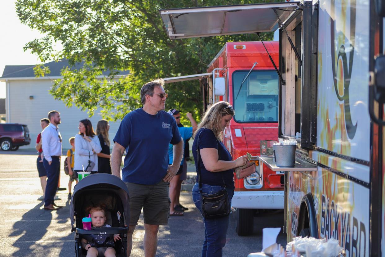 Customers order food from the original Backyard BBQ food truck at Golf Addiction in Sioux Falls on Tuesday, August 30.