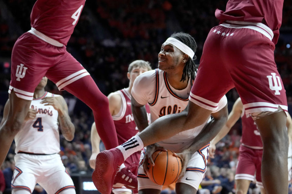 Illinois' Dain Dainja, center, eyes the basket as he gets Indiana's Anthony Walker (4) and Mackenzie Mgbako off their feet during the first half of an NCAA college basketball game, Saturday, Jan. 27, 2024, in Champaign, Ill. (AP Photo/Charles Rex Arbogast)