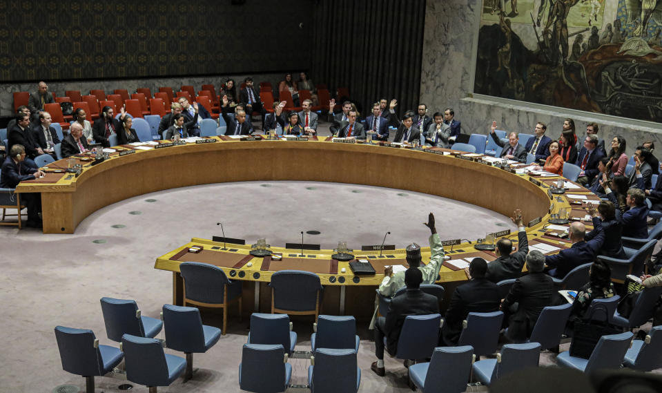 United Nations Security Council members, except Russia and China, raise hands in a vote supporting Yemen related sanctions, Tuesday, Feb. 25, 2020 at U.N. headquarters. The Security Council voted to approve a revised British draft resolution extending targeted sanctions in Yemen. (AP Photo/Bebeto Matthews)