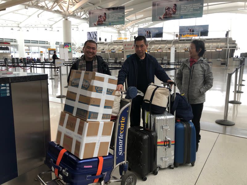 Jonathan Niu waits to accompany his parents back to China