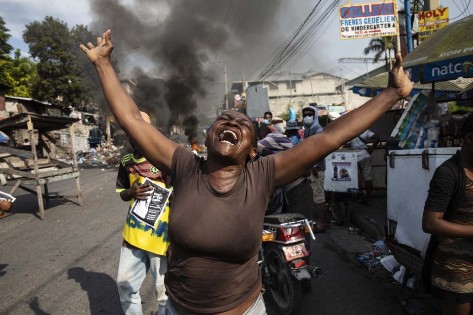 A woman shouts anti-government slogans during a protest organized by friends and relatives of Biana Velizaire, who was kidnapped and held for several days by gang members, in Port-au-Prince, Haiti, Monday, Sept. 27, 2021. Haitian police on Monday launched a special operation in response to the recent surge of kidnappings conducted by gangs. (AP Photo/Rodrigo Abd)